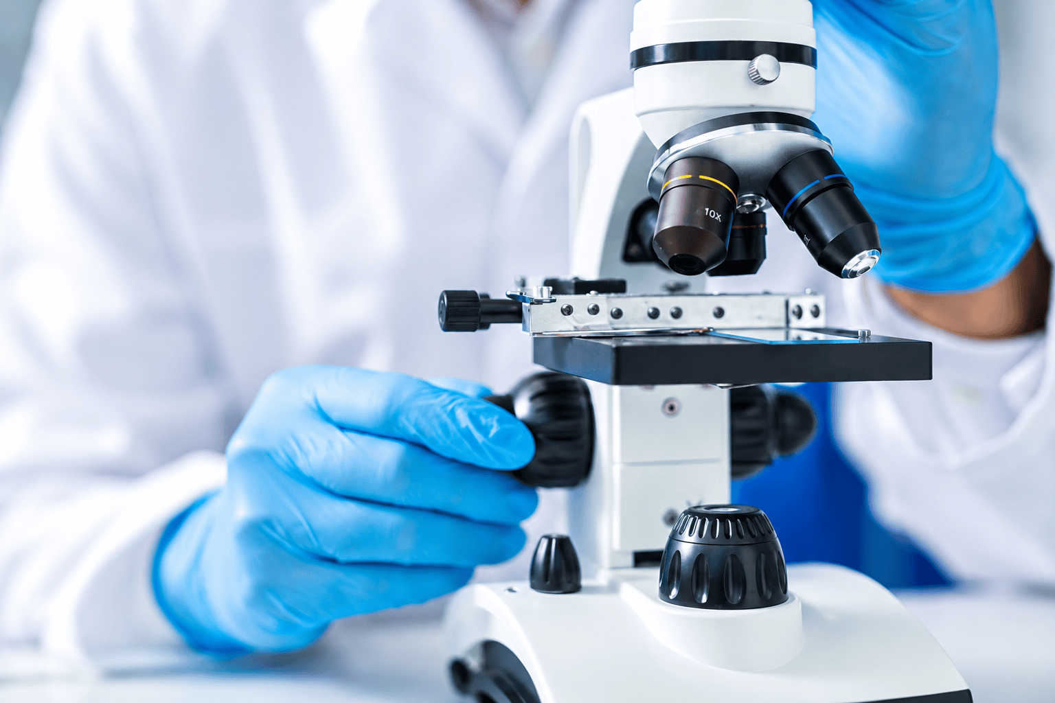 Pharmaceutical researcher examining a sample through a microscope